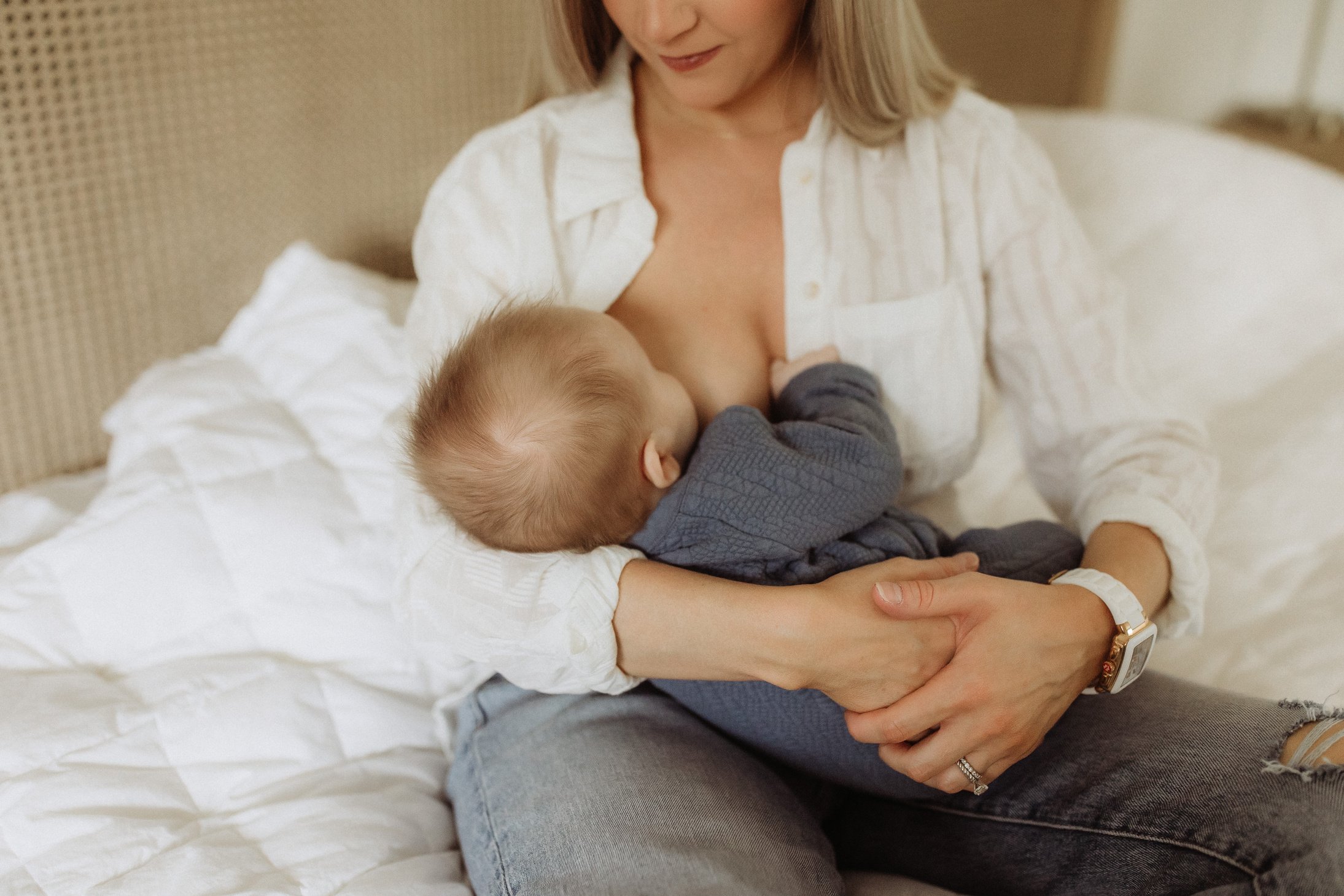 Mother Breastfeeding Son in Bed